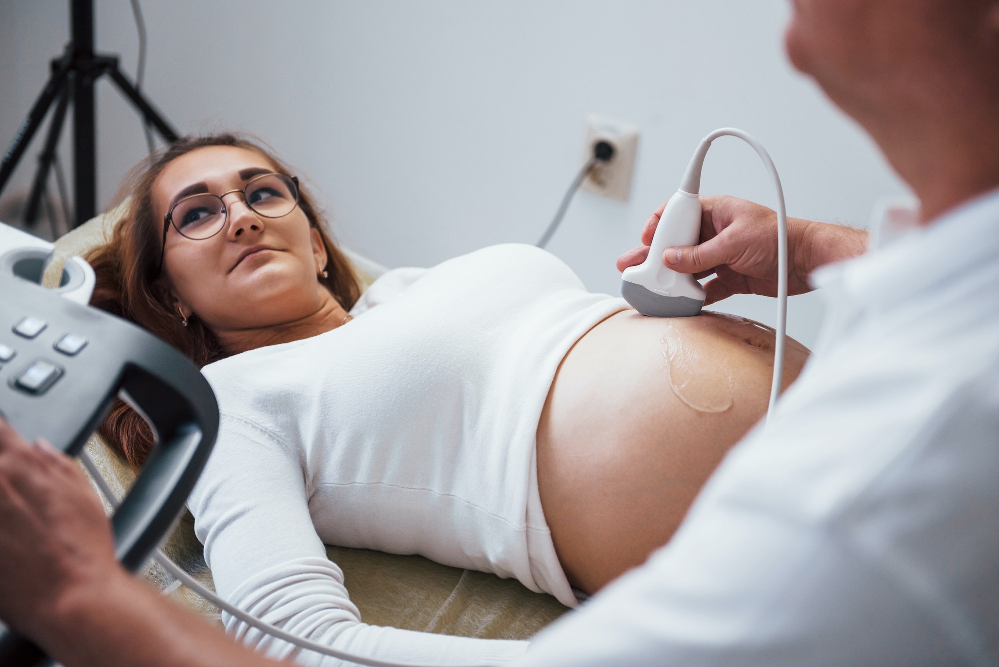 Male doctor does ultrasound for a pregnant woman in the hospital