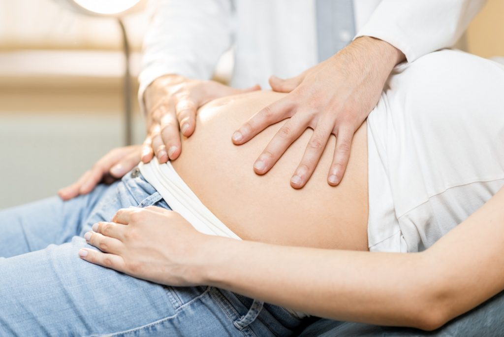 Medical massage of the abdomen of pregnant woman during an examination